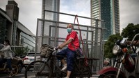 Pengendara sepeda roda tiga melintas di jalanan Wuhan.  Saat ini, populasi jumlah e-bike di seluruh Tiongkok, menurut China Daily, mencapai  200 juta unit. Jumlah itu nyaris sepadan dengan jumlah penduduk di Indonesia.