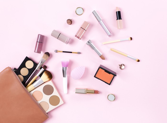 Produk Kecantikan Eco friendly skincare. Natural cosmetics and organic herbs and flowers on pink background, top view, flat lay. Bio research and healthy lifestyle concept.