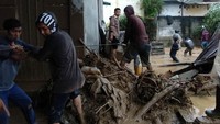 Warga membantu mengevakuasi korban dan harta benda usai banjir bandang yang membawa material batu dan kayu di Desa Paya Tumpi Baru, Kecamatan Kebayakan, Aceh Tengah, Aceh. Banjir bandang akibat tingginya intensitas hujan sejak sepekan terakhir telah merusak puluhan unit rumah warga di desa tersebut.