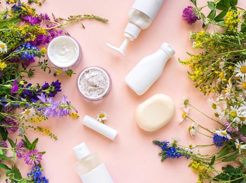 Eco friendly skincare. Natural cosmetics and organic herbs and flowers on pink background, top view, flat lay. Bio research and healthy lifestyle concept.