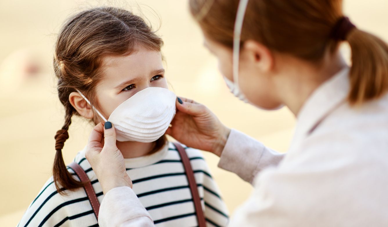 Family with kids in face mask in shopping mall or airport. Mother and child wear facemask during coronavirus and flu outbreak. Virus and illness protection, hand sanitizer in public crowded place.