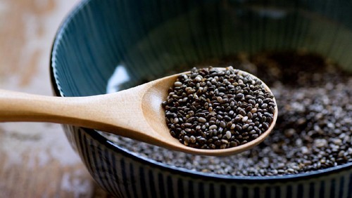 Nutritious chia seeds on a wooden spoon, superfood