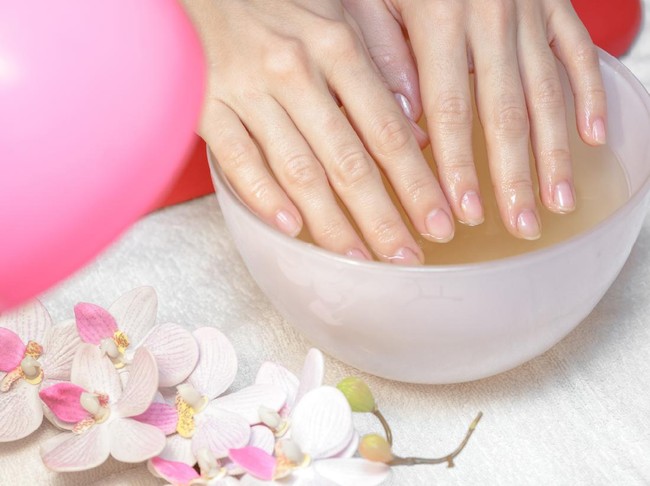 Hands care in the spa. Beautiful womans hands with perfect manicure. Manicurist master makes manicure