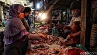 Warga tampak membeli ayam potong.