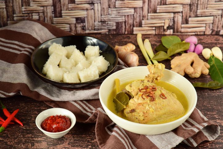 Opor ayam, chicken cooked in coconut milk from Central Java, Indonesia. Served with lontong and sambal. Popular dish for lebaran or Eid al-Fitr