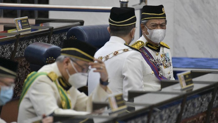 In this photo released by Malaysias Department of Information, Malaysias Prime Minister Muhyiddin Yassin, right, wearing a face mask along with his cabinet members attend the opening ceremony of the third term of the 14th parliamentary session at parliament house in Kuala Lumpur Monday, May 18, 2020.  Malaysias parliament held an unusual half-day sitting Monday, that was kept short due to the COVID-19 pandemic and saw Prime Minister Muhyiddin Yassin dodge a vote of no-confidence against him over two months since he came into power. (Nazri Rapai/Malaysias Department of Information via AP)