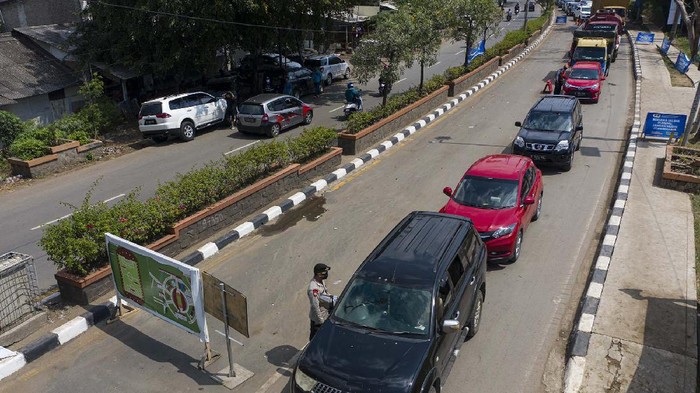 Petugas Kepolisian memeriksa kendaraan pemudik yang melintas di jalan Raya Pacing Bekasi, Jawa Barat, Sabtu (23/5/2020). Pemeriksaan tersebut dilakukan untuk mengantisipasi gelombang pemudik yang akan melintasi jalur Pantura Karawang menuju Jawa Tengah. ANTARA FOTO/Nova Wahyudi/hp.