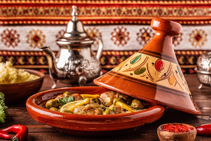 Traditional Moroccan chicken tagine with olives and salted lemons, selective focus.