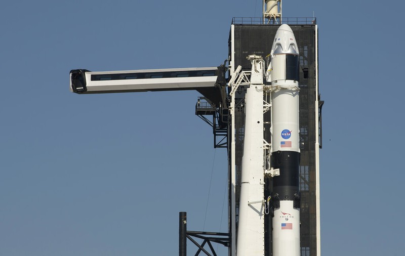 A SpaceX Falcon 9 rocket with the company's Crew Dragon spacecraft is rolled out of the horizontal integration facility at Launch Complex 39A as preparations continue for the Demo-2 mission, Thursday, May 21, 2020, at NASA's Kennedy Space Center in Cape Canaveral, Fla. (Bill Ingalls/NASA via AP)