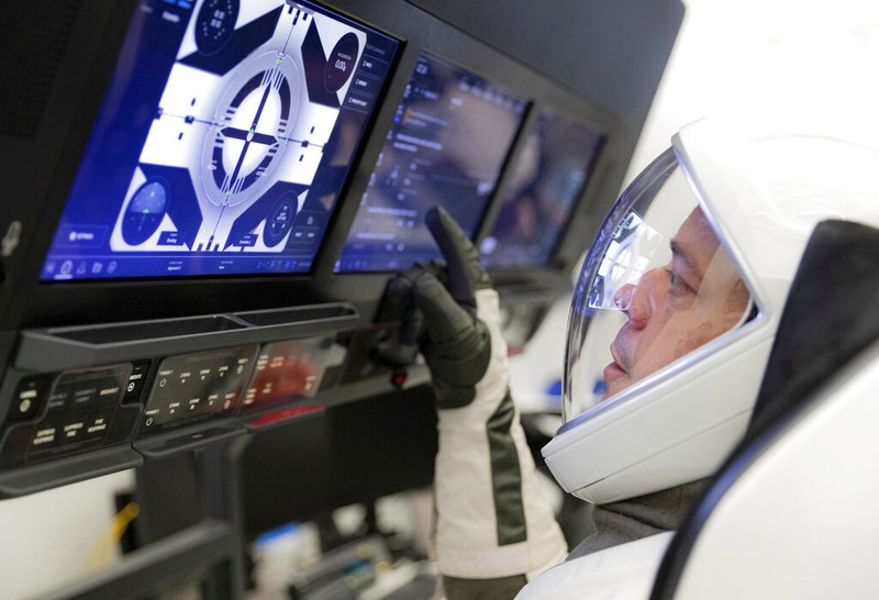 A SpaceX Falcon 9 rocket with the company's Crew Dragon spacecraft is rolled out of the horizontal integration facility at Launch Complex 39A as preparations continue for the Demo-2 mission, Thursday, May 21, 2020, at NASA's Kennedy Space Center in Cape Canaveral, Fla. (Bill Ingalls/NASA via AP)