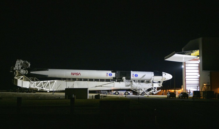 A SpaceX Falcon 9 rocket with the companys Crew Dragon spacecraft is rolled out of the horizontal integration facility at Launch Complex 39A as preparations continue for the Demo-2 mission, Thursday, May 21, 2020, at NASAs Kennedy Space Center in Cape Canaveral, Fla. (Bill Ingalls/NASA via AP)
