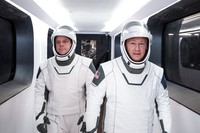 In this Jan. 17, 2020 photo made available by SpaceX, NASA astronauts Bob Behnken, left, and Doug Hurley, wearing SpaceX spacesuits, walk through the Crew Access Arm connecting the launch tower to the SpaceX Crew Dragon spacecraft during a dress rehearsal at NASAs Kennedy Space Center in Cape Canaveral, Fla. For their May 27, 2020 mission, Hurley will be in charge of launch and landing and Behnken will oversee rendezvous and docking at the International Space Station. (SpaceX via AP)