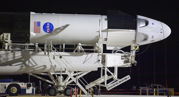 A SpaceX Falcon 9 rocket with the companys Crew Dragon spacecraft is rolled out of the horizontal integration facility at Launch Complex 39A as preparations continue for the Demo-2 mission, Thursday, May 21, 2020, at NASAs Kennedy Space Center in Cape Canaveral, Fla. (Bill Ingalls/NASA via AP)