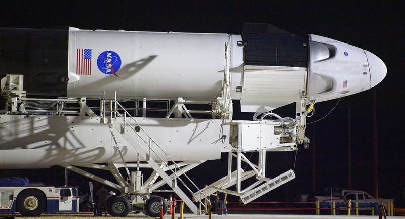 A SpaceX Falcon 9 rocket with the company's Crew Dragon spacecraft is rolled out of the horizontal integration facility at Launch Complex 39A as preparations continue for the Demo-2 mission, Thursday, May 21, 2020, at NASA's Kennedy Space Center in Cape Canaveral, Fla. (Bill Ingalls/NASA via AP)