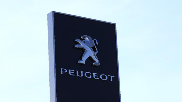 The logo of French car maker maker Peugeot is seen outside a technical center Tuesday, May 26, 2020 in Villacoublay, west of Paris. French President Emmanuel Macron is set to unveil on Tuesday new measures to rescue the country's car industry, which has been hammered by the virus lockdown and the resulting recession. The issue is politically sensitive, since France is proud of its auto industry, which employs 400,000 people in the country and is a big part of its manufacturing sector. (AP Photo/Michel Euler)