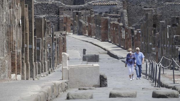 People take photos as they visit the archeological site of Pompeii, Italy, as the site reopened to the public after a two-month lockdown due to the COVID-19 pandemic, Tuesday, May 26, 2020. (AP Photo/Alessandra Tarantino)
