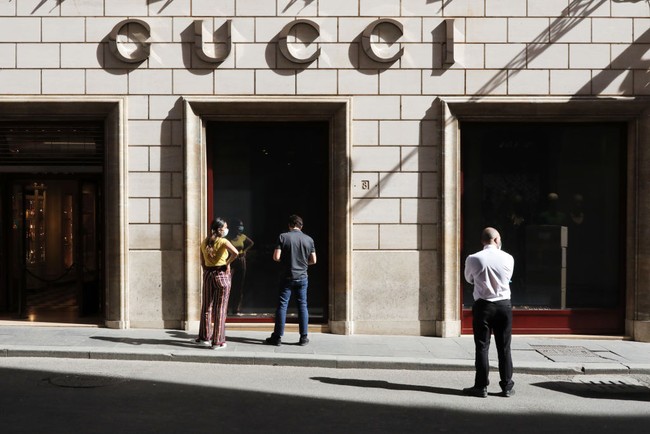ROME, ITALY - MAY 15: Two Gucci employees decide how to separate the entrance and exit of customers in view of the reopening of the store on May 15, 2020 in Rome, Italy. Italy was the first country to impose a nationwide lockdown to stem the transmission of the Coronavirus (Covid-19) and it has started to ease these restrictions in recent weeks. The initial reopening date decided by the government would have been June 1, but due to pressure from the regional governments, trade associations and the public, this process has been accelerated. However, many businesses have complained that the government has not provided complete safety guidelines for the various types of businesses permitted to reopen and, consequently, some have decided to postpone their opening. (Photo by Marco Di Lauro/Getty Images)