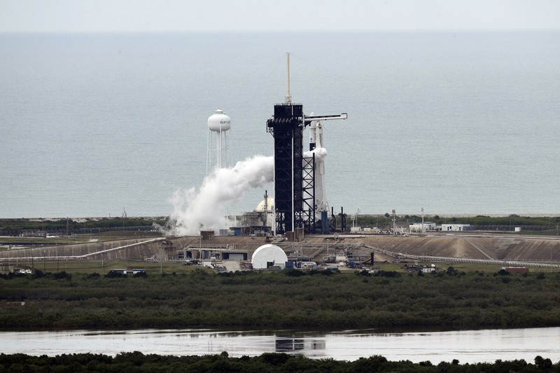 A NASA helicopter escorts the crew to Launch Pad 39-A, Wednesday, May 27, 2020, at Kennedy Space Center in Cape Canaveral, Fla. Two astronauts will fly on the SpaceX Demo-2 mission to the International Space Station scheduled for launch Wednesday. (AP Photo/David J. Phillip)