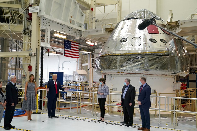 President Donald Trump signs a piece of equipment as he and first lady Melania Trump participate in a tour of NASA facilities before viewing the SpaceX Demonstration Mission 2 Launch at Kennedy Space Center, Wednesday, May 27, 2020, in Cape Canaveral, Fla. Vice President Mike Pence, second from left, second lady Karen Pence, left, and NASA Administrator Jim Bridenstine look on. (AP Photo/Evan Vucci)