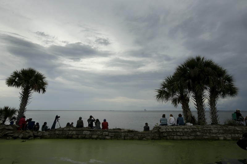 A NASA helicopter escorts the crew to Launch Pad 39-A, Wednesday, May 27, 2020, at Kennedy Space Center in Cape Canaveral, Fla. Two astronauts will fly on the SpaceX Demo-2 mission to the International Space Station scheduled for launch Wednesday. (AP Photo/David J. Phillip)