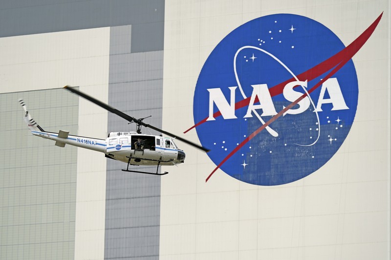 A NASA helicopter escorts the crew to Launch Pad 39-A, Wednesday, May 27, 2020, at Kennedy Space Center in Cape Canaveral, Fla. Two astronauts will fly on the SpaceX Demo-2 mission to the International Space Station scheduled for launch Wednesday. (AP Photo/David J. Phillip)