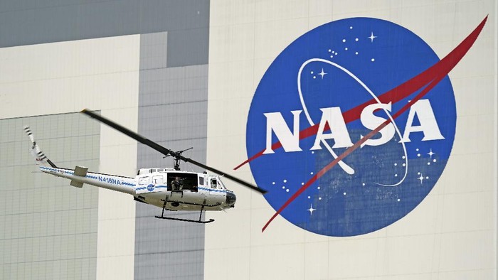A NASA helicopter escorts the crew to Launch Pad 39-A, Wednesday, May 27, 2020, at Kennedy Space Center in Cape Canaveral, Fla. Two astronauts will fly on the SpaceX Demo-2 mission to the International Space Station scheduled for launch Wednesday. (AP Photo/David J. Phillip)