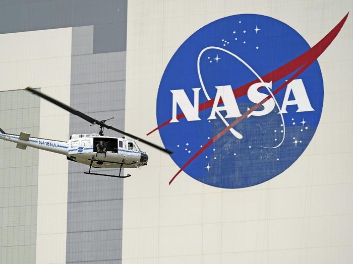 A NASA helicopter escorts the crew to Launch Pad 39-A, Wednesday, May 27, 2020, at Kennedy Space Center in Cape Canaveral, Fla. Two astronauts will fly on the SpaceX Demo-2 mission to the International Space Station scheduled for launch Wednesday. (AP Photo/David J. Phillip)
