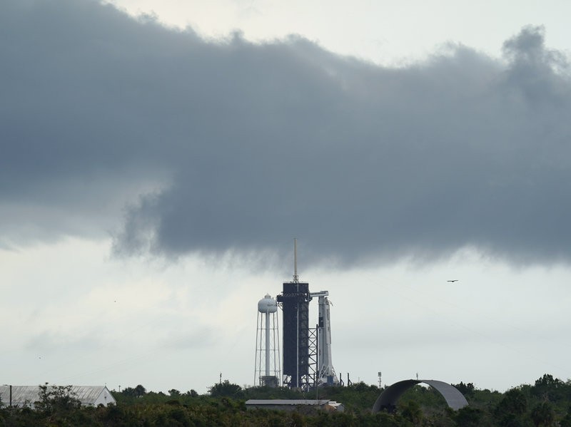 A NASA helicopter escorts the crew to Launch Pad 39-A, Wednesday, May 27, 2020, at Kennedy Space Center in Cape Canaveral, Fla. Two astronauts will fly on the SpaceX Demo-2 mission to the International Space Station scheduled for launch Wednesday. (AP Photo/David J. Phillip)