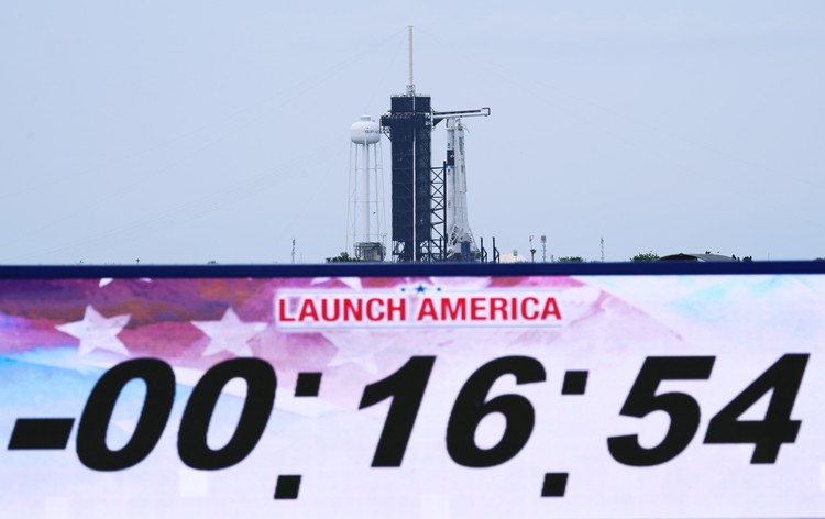 A NASA helicopter escorts the crew to Launch Pad 39-A, Wednesday, May 27, 2020, at Kennedy Space Center in Cape Canaveral, Fla. Two astronauts will fly on the SpaceX Demo-2 mission to the International Space Station scheduled for launch Wednesday. (AP Photo/David J. Phillip)