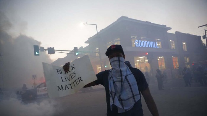 Denver Police Department officers stand over a man who fell to the street after they used tear gas and rubber bullets to disperse a protest outside the State Capitol over the death of George Floyd, a handcuffed black man who died in police custody in Minneapolis, late Thursday, May 28, 2020, in Denver. (AP Photo/David Zalubowski)