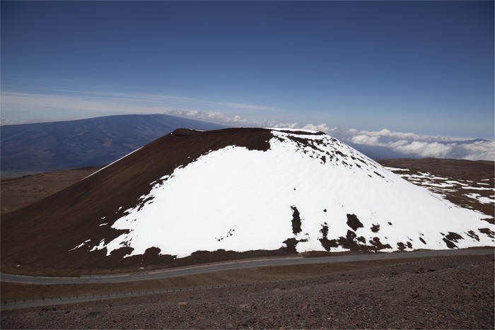 Cinder cone on the summit of Mauna Kea in Winter on the Big Island of Hawaii. Mauna Loa seen in the background.