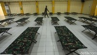 Seorang petugas merapikan tempat tidur portabel di GOR Jakarta Pusat.