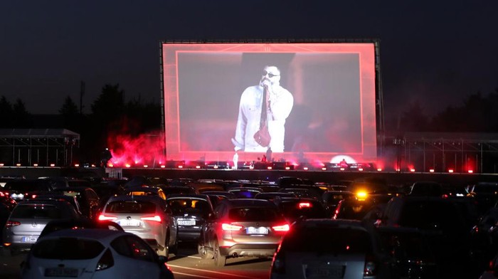SYDNEY, AUSTRALIA - MAY 28: A group watch the movie Dirty Dancing from inside their car at Movin Car Outdoor Car Cinema on May 28, 2020 in Sydney, Australia. Originally an outdoor cinema where patrons would watch the screen from beds, the cinema has been turned into a drive in theatre to allow Sydneysiders the chance to go to the movies safely and in line with current COVID-19 restrictions.  (Photo by Mark Metcalfe/Getty Images)