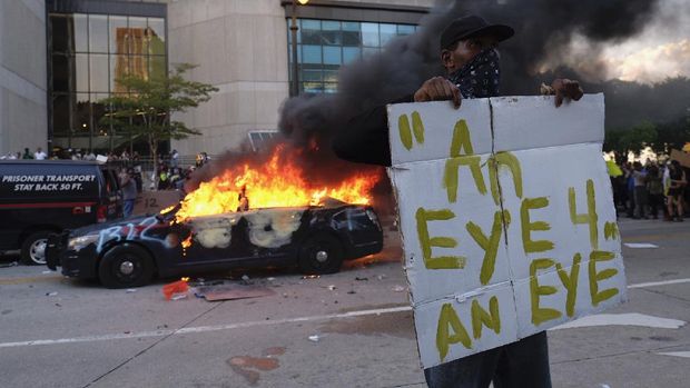 A police car burns during a protest in Atlanta, Friday, May 29, 2020. Protesters marched for George Floyd, who died after being restrained by Minneapolis police officers on Memorial Day. (Ben Gray/Atlanta Journal-Constitution via AP)