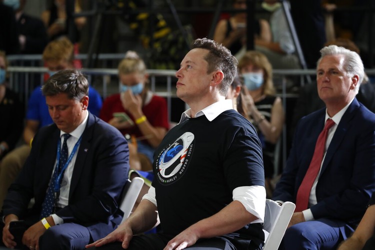 NASA SpaceX Home Launch Tesla and SpaceX Chief Executive Officer Elon Musk hugs his brother Kimbal Musk during an event at the Vehicle Assembly Building on Saturday, May 23, 2020, at NASAs Kennedy Space Center in Cape Canaveral, Fla. The event occurred after a rocket ship designed and built by SpaceX lifted off on Saturday with two Americans on a history-making flight to the International Space Station. House Minority Leader Kevin McCarthy of Calif., applauds at right. (AP Photo/Alex Brandon)