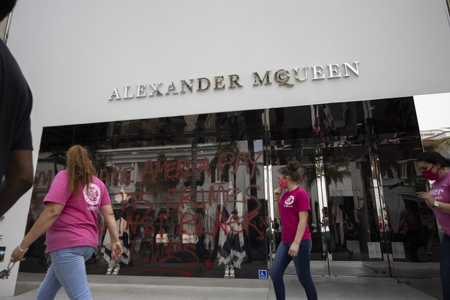 Aksi protes kematian George Floyd meluas ke berbagai negara bagian dan kota di Amerika Serikat, tanpa terkecuali Los Angeles, California. Sayangnya, unjuk rasa yang menuntut keadilan dan menolak aksi rasisme itu berujung aksi penjarahan dan vandalisme. Butik-butik mewah di surga belanja kaum elite, Rodeo Drive, pun menjadi korban. Salah satunya butik desainer dan label Inggris Alexander McQueen. Tampak kaca bagian depan penuh coretan, Minggu (31/5/2020). (Foto: AP/Christian Monterrosa)