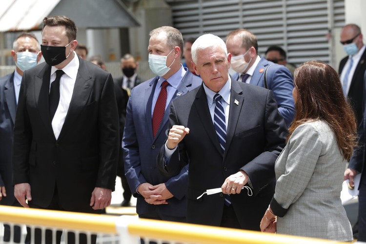 Vice President Mike Pence, his wife Karen, right, NASA administrator, Jim Bridenstine, center and CEO of SpaceX, Elon Musk, talk to the media after NASA astronauts Douglas Hurley and Robert Behnken left the Neil A. Armstrong Operations and Checkout Building on their way to Pad 39-A, at the Kennedy Space Center in Cape Canaveral, Fla., Wednesday, May 27, 2020. The two astronauts will fly on a SpaceX test flight to the International Space Station. For the first time in nearly a decade, astronauts will blast into orbit aboard an American rocket from American soil, a first for a private company. (AP Photo/John Raoux)