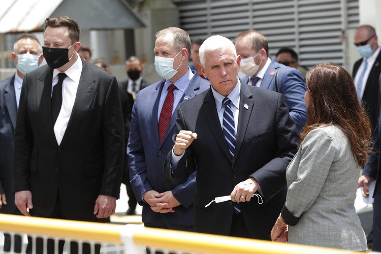 Elon Musk Vice President Mike Pence, his wife Karen, right, NASA administrator, Jim Bridenstine, center and CEO of SpaceX, Elon Musk, talk to the media after NASA astronauts Douglas Hurley and Robert Behnken left the Neil A. Armstrong Operations and Checkout Building on their way to Pad 39-A, at the Kennedy Space Center in Cape Canaveral, Fla., Wednesday, May 27, 2020. The two astronauts will fly on a SpaceX test flight to the International Space Station. For the first time in nearly a decade, astronauts will blast into orbit aboard an American rocket from American soil, a first for a private company. (AP Photo/John Raoux)