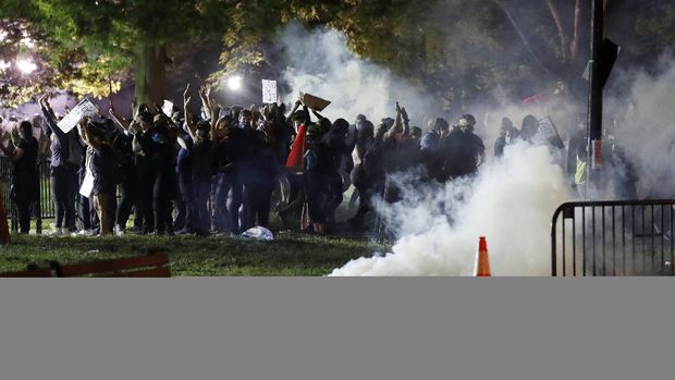 Tear gas billows as demonstrators gather in Lafayette Park to protest the death of George Floyd, Sunday, May 31, 2020, near the White House in Washington. Floyd died after being restrained by Minneapolis police officers (AP Photo/Alex Brandon)