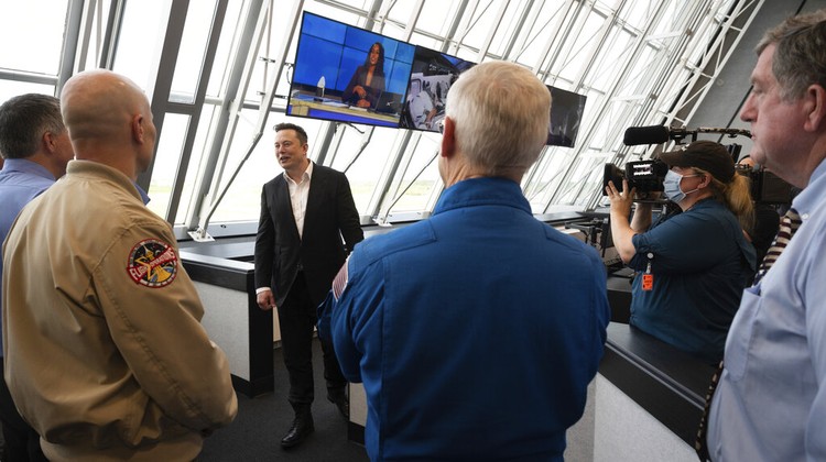 Elon Musk Vice President Mike Pence, his wife Karen, right, NASA administrator, Jim Bridenstine, center and CEO of SpaceX, Elon Musk, talk to the media after NASA astronauts Douglas Hurley and Robert Behnken left the Neil A. Armstrong Operations and Checkout Building on their way to Pad 39-A, at the Kennedy Space Center in Cape Canaveral, Fla., Wednesday, May 27, 2020. The two astronauts will fly on a SpaceX test flight to the International Space Station. For the first time in nearly a decade, astronauts will blast into orbit aboard an American rocket from American soil, a first for a private company. (AP Photo/John Raoux)