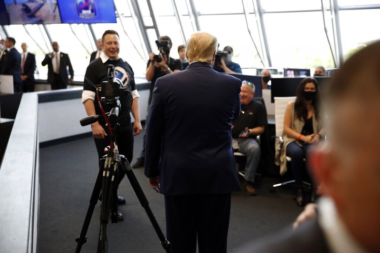 Elon Musk Vice President Mike Pence, his wife Karen, right, NASA administrator, Jim Bridenstine, center and CEO of SpaceX, Elon Musk, talk to the media after NASA astronauts Douglas Hurley and Robert Behnken left the Neil A. Armstrong Operations and Checkout Building on their way to Pad 39-A, at the Kennedy Space Center in Cape Canaveral, Fla., Wednesday, May 27, 2020. The two astronauts will fly on a SpaceX test flight to the International Space Station. For the first time in nearly a decade, astronauts will blast into orbit aboard an American rocket from American soil, a first for a private company. (AP Photo/John Raoux)