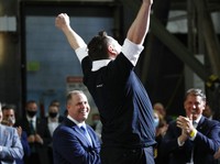 Tesla and SpaceX Chief Executive Officer Elon Musk jumps in the air as people applaud during an event at the Vehicle Assembly Building on Saturday, May 23, 2020, at NASAs Kennedy Space Center in Cape Canaveral, Fla. The event occurred after a rocket ship designed and built by SpaceX lifted off on Saturday with two Americans on a history-making flight to the International Space Station. NASA Administrator Jim Bridenstine looks on at left. (AP Photo/Alex Brandon)