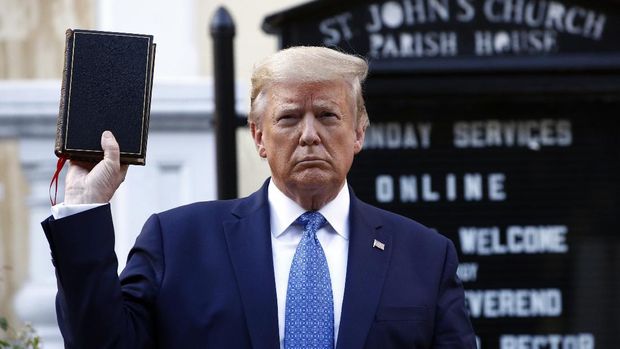 President Donald Trump holds a Bible as he visits outside St. John's Church across Lafayette Park from the White House Monday, June 1, 2020, in Washington. Part of the church was set on fire during protests on Sunday night. (AP Photo/Patrick Semansky)