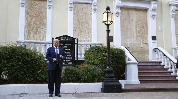 President Donald Trump holds a Bible as he visits outside St. John's Church across Lafayette Park from the White House Monday, June 1, 2020, in Washington. Part of the church was set on fire during protests on Sunday night. (AP Photo/Patrick Semansky)
