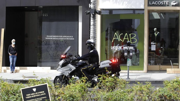 Protesters march in Beverly Hills, Calif., on Saturday, May 30, 2020, over the death of George Floyd, who died in police custody on Memorial Day in Minneapolis. (AP Photo/Christian Monterrosa)