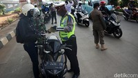 Petugas gabungan yang melakukan pemeriksaan pengendara yang memasuki wilayah DKI Jakarta terdiri dari Polri, TNI, dan Satpol PP.