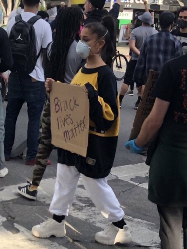 Ariana Grande dipuji netizen karena memanfaatkan nama besarnya untuk mengangkat isu rasisme dengan ikut demo Black Lives Matter untuk George Floyd. Mengenakan sweater oversized dan celana putih, ia juga membawa papan bertulisan Black Lives Matter. Foto: Twitter
