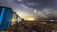 Bidikan malam hari di Pantai Charmouth menampilkan jutaan bintang dari Galaksi Bima Sakti yang indah.