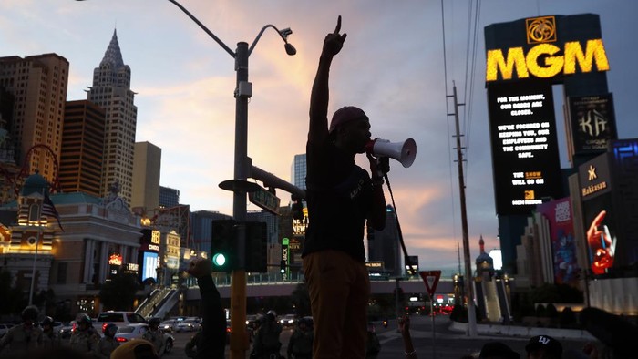 Protesters rally on the Las Vegas Strip Sunday, May 31, 2020, in Las Vegas, over the death of George Floyd, a black man who was in police custody in Minneapolis. Floyd died after being restrained by Minneapolis police officers on Memorial Day. (AP Photo/Steve Marcus)