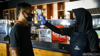 Para pekerja juga harus mengecek suhu tubuhnya sebelum bekerja melayani pembeli.